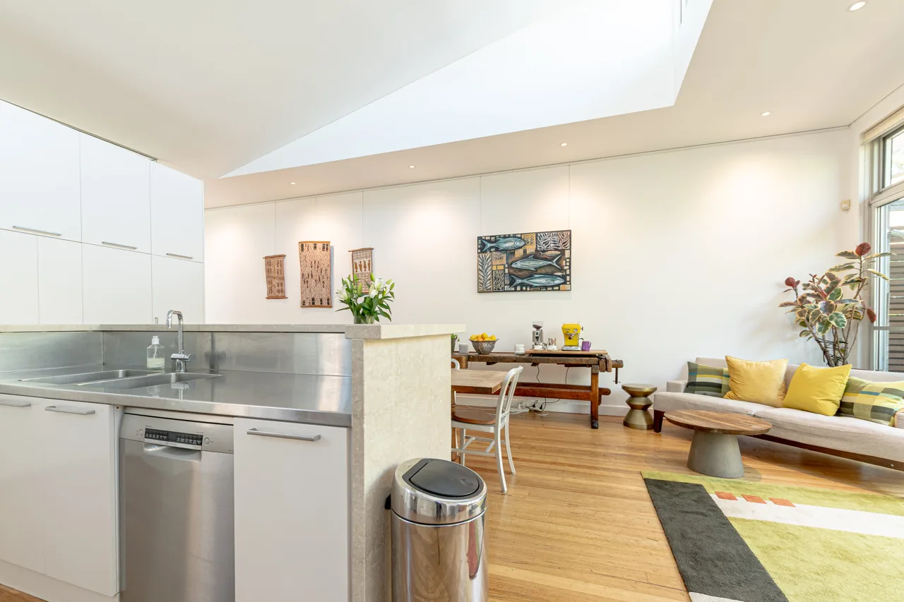 Bright kitchen with stainless steel island and white cabinetry